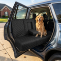 Golden retriever sitting on the black quilted waterproof back seat cover in an SUV